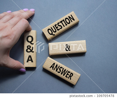 Q and A - Question and Answer. Wooden cubes with words Q and A. Businessman hand. Beautiful grey background. Business and Q and A concept. Copy space. 109705478