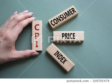 CPI - Consumer Price Index symbol. Concept word CPI on wooden blocks. Businessman hand. Beautiful grey green background. Business and CPI concept. Copy space. 109705479