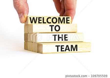 Welcome to the team symbol. Concept words Welcome to the team on wooden block. Beautiful white table white background. Businessman hand. Business, motivational and welcome to the team concept. 109705509