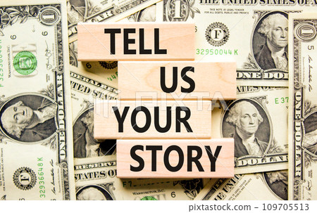 Tell us your story symbol. Concept word Tell us your story on beautiful wooden block. Dollar bills. Beautiful background from dollar bills. Business tell us your story concept. Copy space. Tell us your story symbol. Concept word Tell us your story on beautiful wooden block. Dollar bills. Beautiful background from dollar bills. Business tell us your story concept. Copy space. 109705513