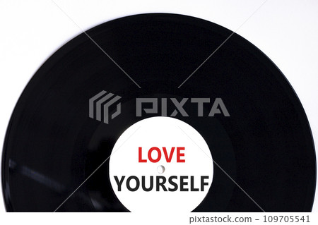 Love yourself symbol. Concept words Love yourself on beautiful black vinyl disk. Beautiful white table white background. Psychology love yourself concept. Copy space. Love yourself symbol. Concept words Love yourself on beautiful black vinyl disk. Beautiful white table white background. Psychology love yourself concept. Copy space. 109705541