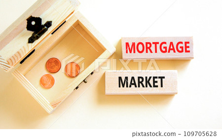Mortgage market symbol. Concept words Mortgage market on beautiful wooden blocks. Beautiful white table white background. Wooden beautiful chest coins. Business mortgage market concept. Copy space. 109705628