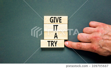 Give it a try symbol. Concept word Give it a try on beautiful wooden block. Beautiful grey table grey background. Businessman hand. Business give it a try concept. Copy space. Give it a try symbol. Concept word Give it a try on beautiful wooden block. Beautiful grey table grey background. Businessman hand. Business give it a try concept. Copy space. 109705687