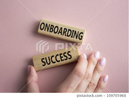 Onboarding Success symbol. Concept word Onboarding Success on wooden blocks. Businessman hand. Beautiful pink background. Business and Onboarding Success concept. Copy space 109705968