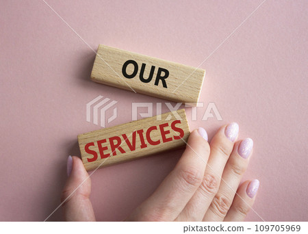 Our services symbol. Concept words Our services on wooden blocks. Businessman hand. Beautiful pink background. Business and Our services concept. Copy space. 109705969
