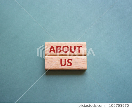 About us symbol. Concept word About us on wooden blocks. Beautiful grey green background. Business and About us concept. Copy space 109705970