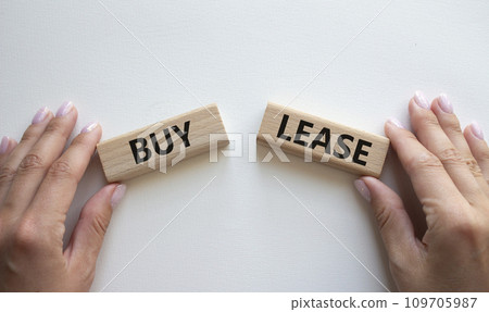 Buy or Lease symbol. Concept word Buy or Lease on wooden blocks. Businessman hand. Beautiful white background. Business and Buy or Lease concept. Copy space Buy or Lease symbol. Concept word Buy or Lease on wooden blocks. Businessman hand. Beautiful white background. Business and Buy or Lease concept. Copy space 109705987