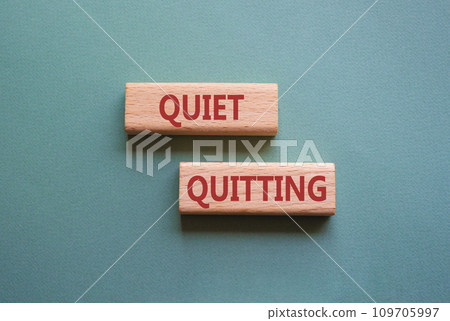 Quiet quitting symbol. Concept word Quiet quitting on wooden blocks. Beautiful grey green background. Business and Quiet quitting concept. Copy space. Quiet quitting symbol. Concept word Quiet quitting on wooden blocks. Beautiful grey green background. Business and Quiet quitting concept. Copy space. 109705997