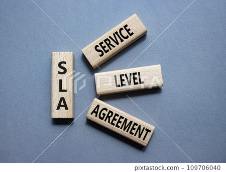 SLA - Service Level Agreement. Wooden blocks with word SLA. Beautiful grey background. Business and Service Level Agreement concept. Copy space. 109706040