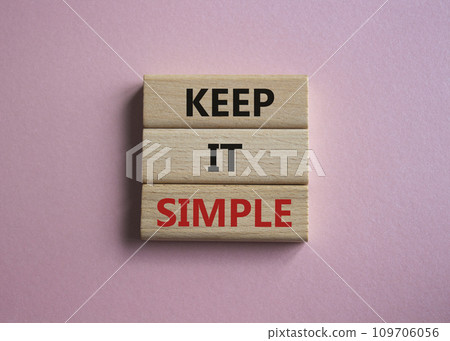 Keep it Simple symbol. Concept words Keep it Simple on wooden blocks. Beautiful pink background. Business and Keep it Simple concept. Copy space. 109706056