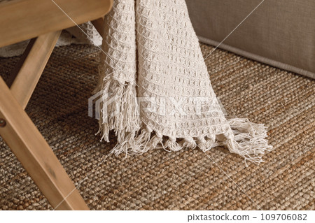 Fringed knitted blanket detail close up. Wabi-sabi interior decoration concept 109706082