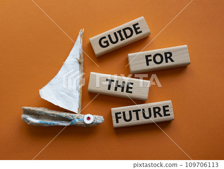 Guide for the future symbol. Wooden blocks with words Guide for the future. Beautiful orange background with boat. Business and Guide for the future concept. Copy space. Guide for the future symbol. Wooden blocks with words Guide for the future. Beautiful orange background with boat. Business and Guide for the future concept. Copy space. 109706113