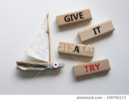 Give it a try symbol. Concept words Give it a try on wooden blocks. Beautiful white background with boat. Business and Give it a try concept. Copy space. Give it a try symbol. Concept words Give it a try on wooden blocks. Beautiful white background with boat. Business and Give it a try concept. Copy space. 109706115