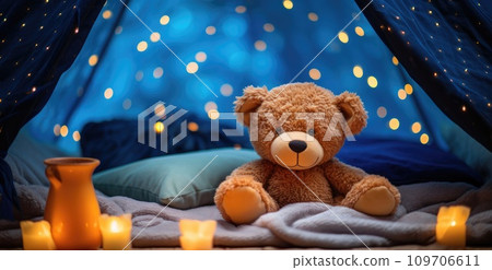 a bear is sitting on a blue blanket 109706611