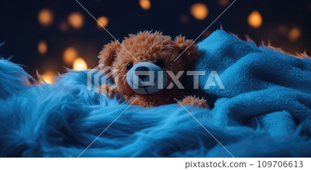 a bear is sitting on a blue blanket a bear is sitting on a blue blanket 109706613