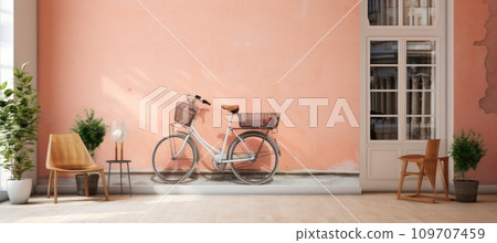 old wooden bicycles by the door of a pink wall 109707459