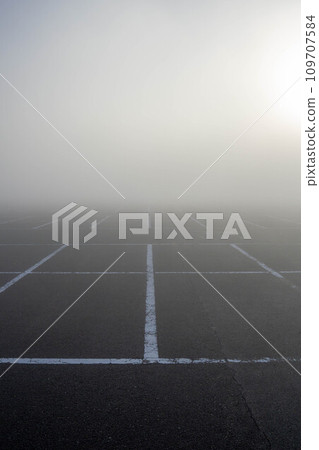 parking lot shrouded in fog parking lot shrouded in fog 109707584
