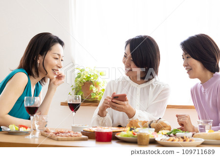 Women enjoying a home party Women enjoying a home party 109711689