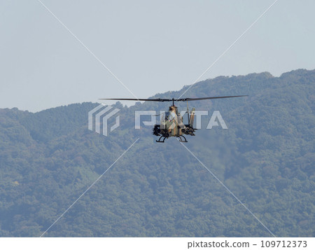 Anti-tank helicopter AH-1S Cobra flying over Yao Garrison 109712373