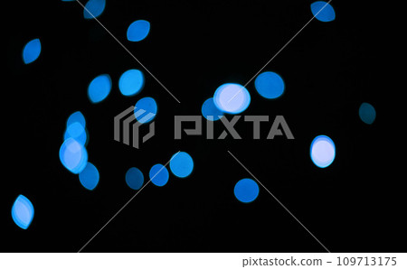 Blue, glitter and bokeh in a studio with dark background for celebration, event or party. Confetti, lights and color sparkles for magic, shine or glow for festive by black backdrop with mockup. 109713175