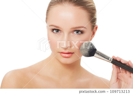 Woman, makeup and beauty with brush, portrait and model for skin, cosmetics on white background. Face, beautiful and headshot with shine, skincare or clean for facial glow, cosmetology or grooming Woman, makeup and beauty with brush, portrait and model for skin, cosmetics on white background. Face, beautiful and headshot with shine, skincare or clean for facial glow, cosmetology or grooming 109713213