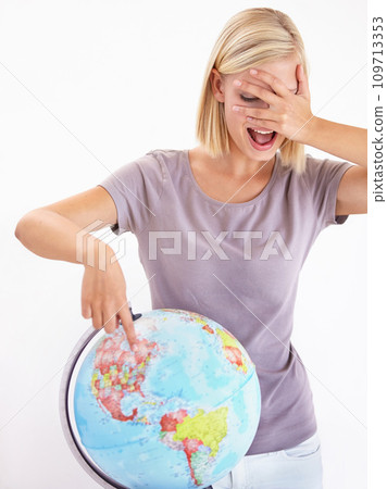 Wow, guess or pointing and a woman with a globe in studio on a white background for destination choice. World, planet and hand gesture to a location on earth for overseas travel decision or selection 109713353