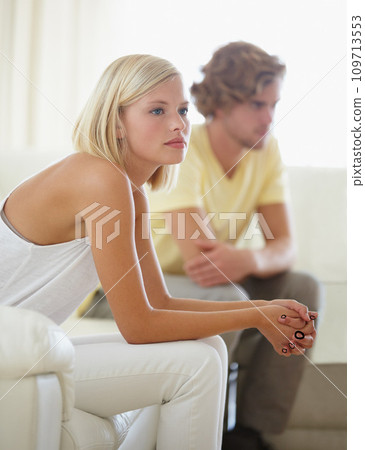 Fight, divorce and couple on sofa with stress, anxiety or cheating depression in their home. Marriage, crisis and frustrated woman overthinking in living room with commitment, doubt or liar conflict 109713553