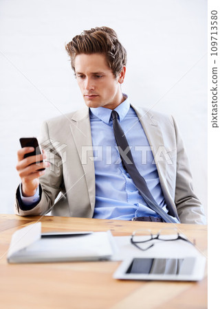 Businessman, phone and networking or email in office, connection and contact for company. Male person, professional and communication or mobile application, technology and smartphone for discussion Businessman, phone and networking or email in office, connection and contact for company. Male person, professional and communication or mobile application, technology and smartphone for discussion 109713580