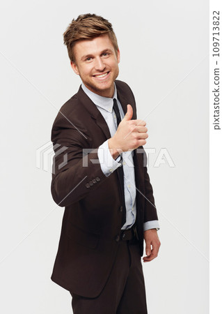 Happy, portrait and business man with thumbs up in studio for feedback, review or vote support on white background. Emoji, face or entrepreneur with success, thank you or service excellence guarantee 109713822