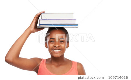 Portrait, smile and black girl with books on her head, education and balance isolated on a white studio background. Face, African person and model with mockup space and learning with knowledge 109714016