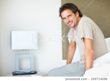 Portrait, smile and man on bed in the morning after nap, break and awake from comfortable sleep at home. Happy mature guy wake up, relax in bedroom and apartment for healthy rest, routine or cosy day Portrait, smile and man on bed in the morning after nap, break and awake from comfortable sleep at home. Happy mature guy wake up, relax in bedroom and apartment for healthy rest, routine or cosy day 109714096
