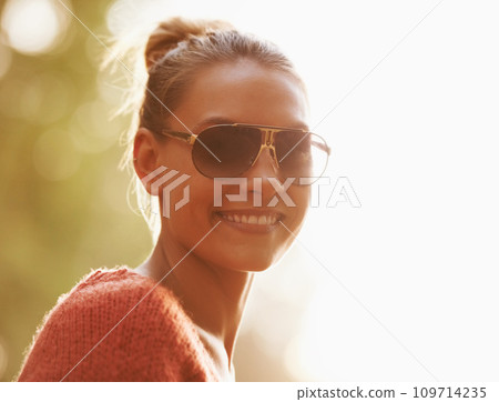 Sunglasses, sunshine and portrait of woman in nature for holiday, summer vacation and adventure. Happy, smile and face of person outdoors with fashion accessory, trendy style and happiness in woods Sunglasses, sunshine and portrait of woman in nature for holiday, summer vacation and adventure. Happy, smile and face of person outdoors with fashion accessory, trendy style and happiness in woods 109714235