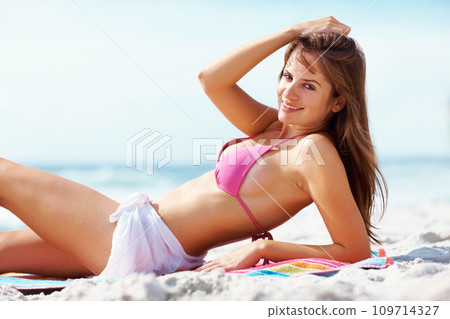 Portrait, smile and woman in bikini relax at beach blanket on holiday, vacation or travel. Body, happy girl and swimwear at ocean, sand and sea for freedom, tropical summer or beauty mockup in Hawaii 109714327