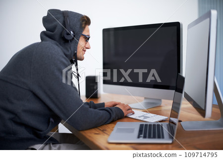Man, hoodie and hacker on computer for digital information for password error, cyber security or database glitch. Male person, dual screen and online programming for malware code, stealing or network 109714795