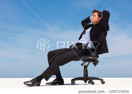 Business man, relax and outdoor nap of a corporate professional in a chair with peace from success. Worker, calm and young male employee and suit with mockup space and blue sky with job and career 109715034