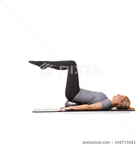 Exercise legs, pilates and woman on ball in workout, training or healthy body isolated on a white studio background mockup space. Core, mat and person on equipment for balance, sports and fitness 109715081