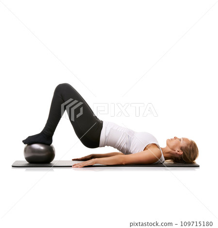 Fitness, stretching and woman on floor with ball for pilates, wellness care and health in studio. Gym, training and girl on mat with cardio, lying and muscle workout isolated on white background Fitness, stretching and woman on floor with ball for pilates, wellness care and health in studio. Gym, training and girl on mat with cardio, lying and muscle workout isolated on white background 109715180