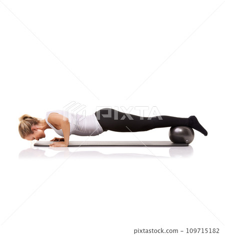 Fitness, push up and woman on floor with ball for pilates, body building care and health in studio. Gym, training and girl on mat with power, energy and muscle workout isolated on white background. Fitness, push up and woman on floor with ball for pilates, body building care and health in studio. Gym, training and girl on mat with power, energy and muscle workout isolated on white background. 109715182