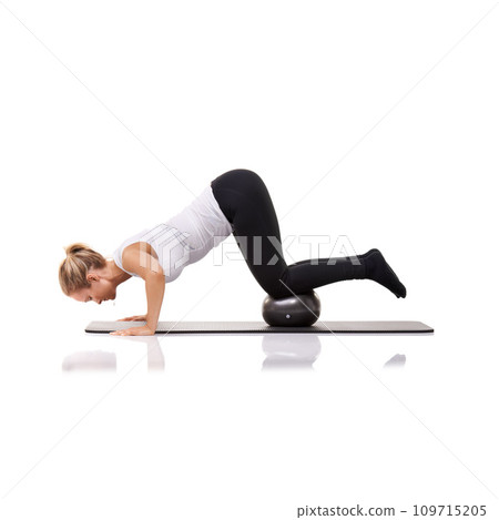 Balance, exercise and woman on floor with ball for pilates, body building care and health in studio. Gym, training and girl on mat with cardio, energy and muscle workout isolated on white background. 109715205
