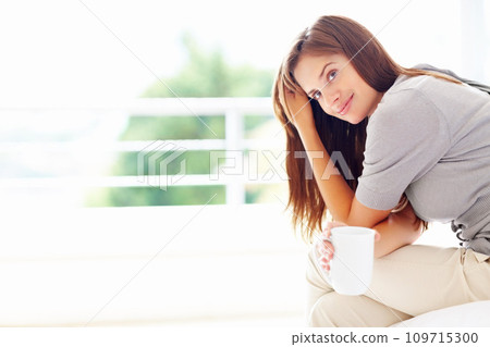 Happy, coffee and portrait of woman in home for relaxing, calm and peace on weekend. House, morning and face of person smile with mug for warm beverage, tea and drinking caffeine for happiness 109715300