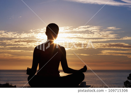 Person, meditation and yoga in beach sunset for zen fitness, calm exercise and mindfulness or holistic wellness in silhouette. Back and nature with lotus hands, outdoor peace and mental health by sea 109715306