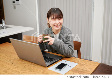 Remote work, woman taking a break, working from home Remote work, woman taking a break, working from home 109715697