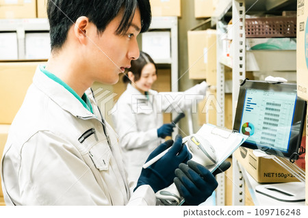 Male staff checking inventory at warehouse Male staff checking inventory at warehouse 109716248