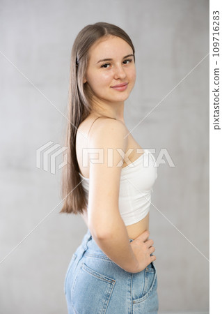 Young smiling woman posing in studio 109716283