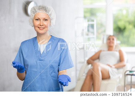 Adult female doctor posing in medical room Adult female doctor posing in medical room 109716524