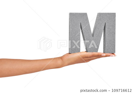 Woman, hand and letter M or font in studio for advertising, learning or teaching on mock up. Sign, alphabet or character for reading, text or communication and grammar or symbol on white background 109716612