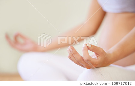 Pregnant woman, yoga meditation and hands in studio with relax wellness and mindfulness for prenatal care. Young person, zen or lotus pose for breath exercise in maternity training or peace in class 109717012