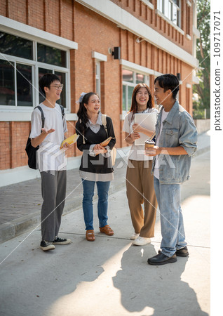 Group of positive diverse Asian college student friends are talking after classes in their campus. Group of positive diverse Asian college student friends are talking after classes in their campus. 109717071