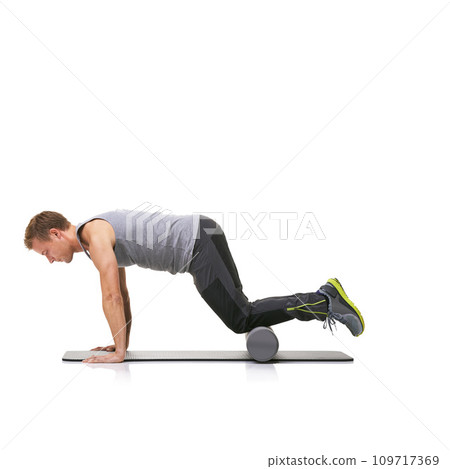 Pilates, foam roller and man in a studio for exercise, stretching or gym routine with yoga mat. Stability, balance and young male athlete from Australia with body workout by white background. 109717369