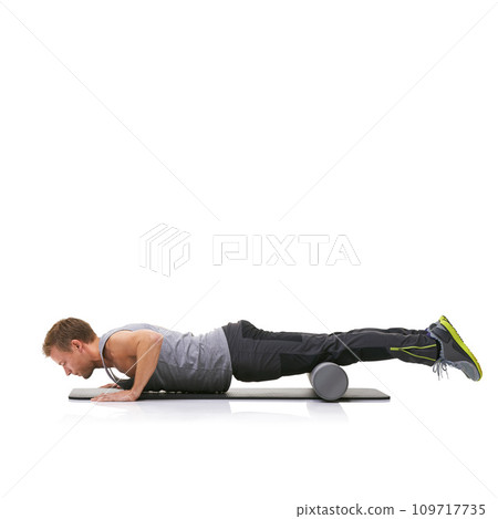 Training, foam roller and man in floor push up for bodybuilding commitment, muscle growth or arm strength exercise. Plank balance, mockup studio space and male fitness athlete on white background 109717735